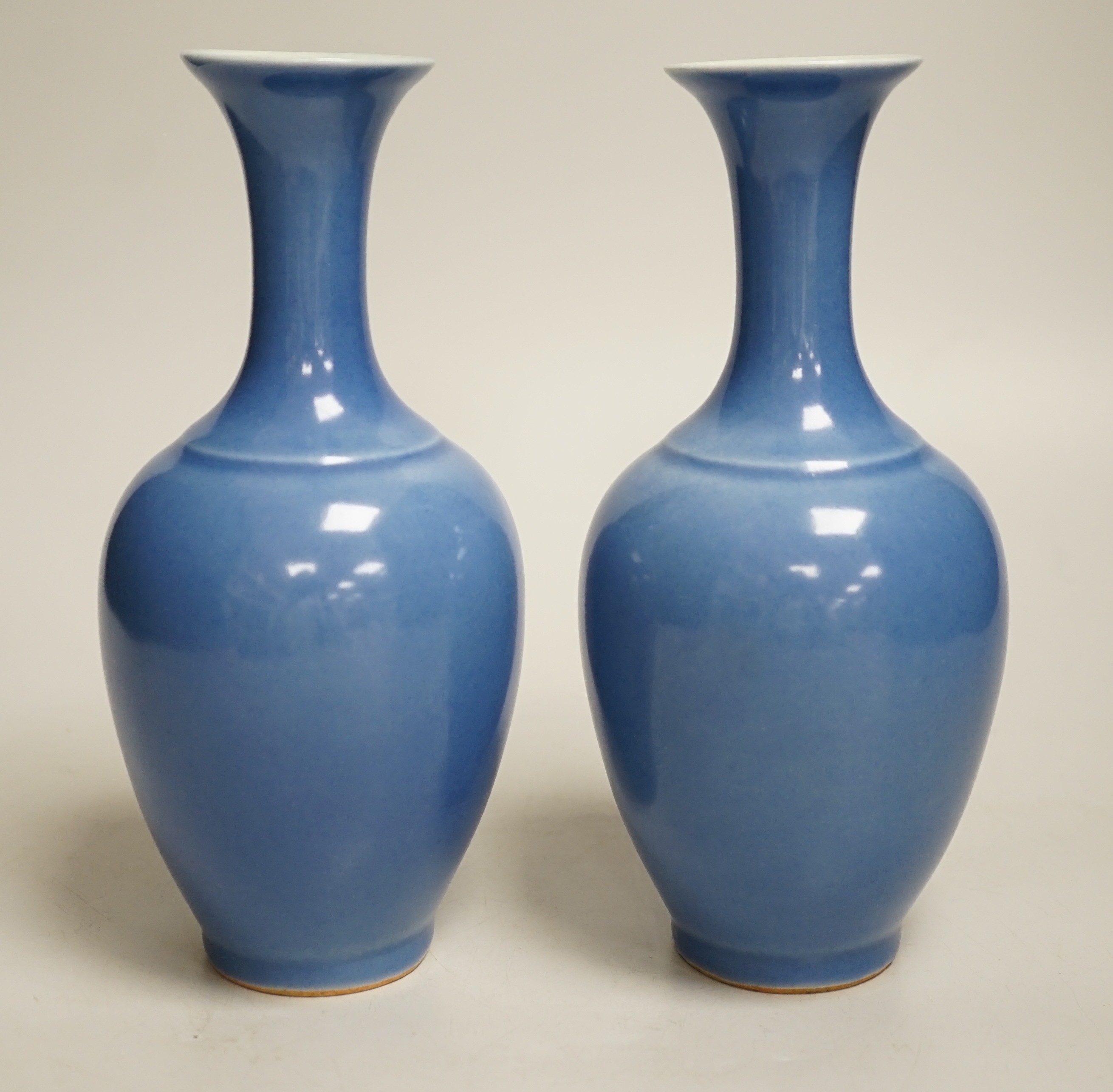 A pair of Chinese blue glazed vases, 21cm